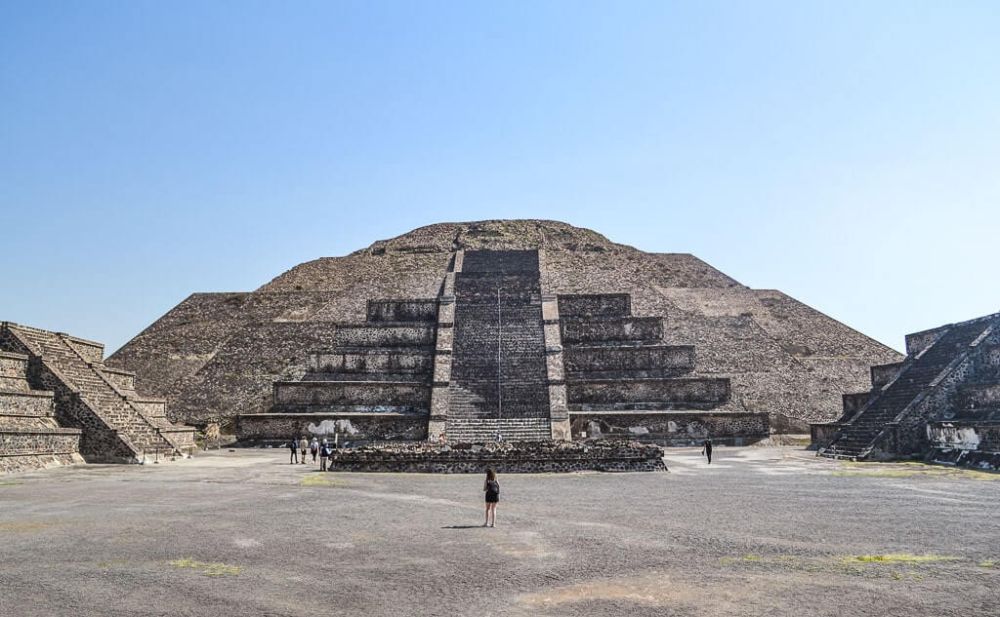 A pyramid with a long stairway going up its center front. Other stairways visible going out of the shot to left and right.