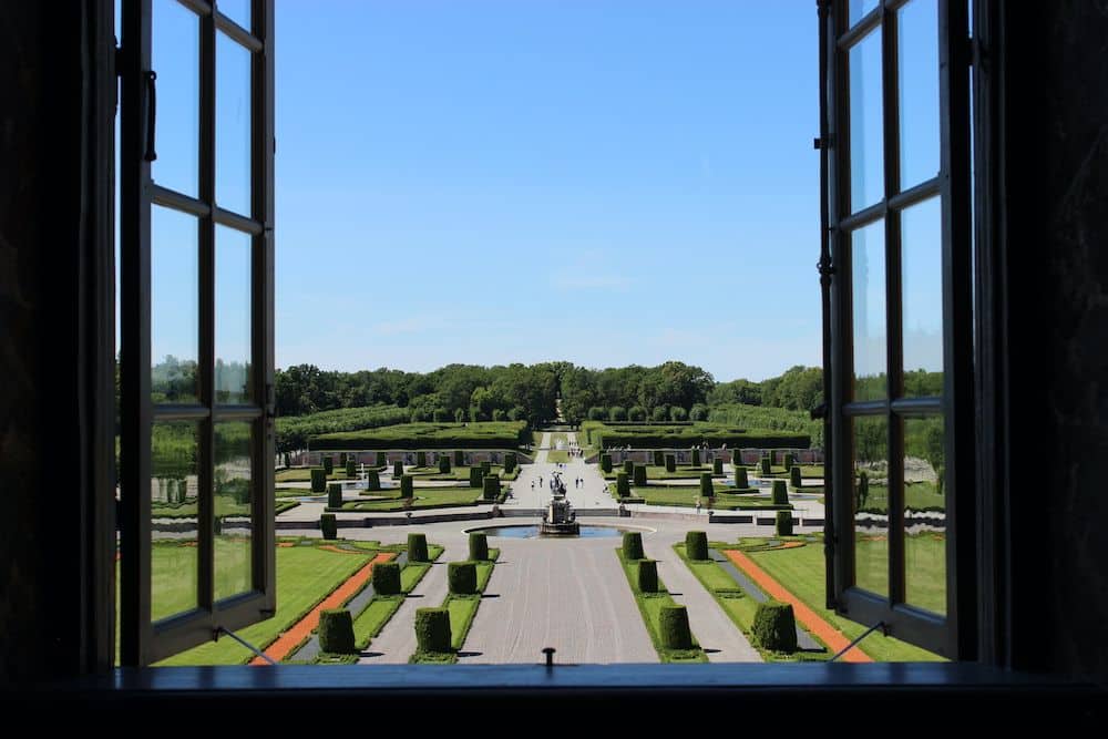 View out a window to a very formal garden.