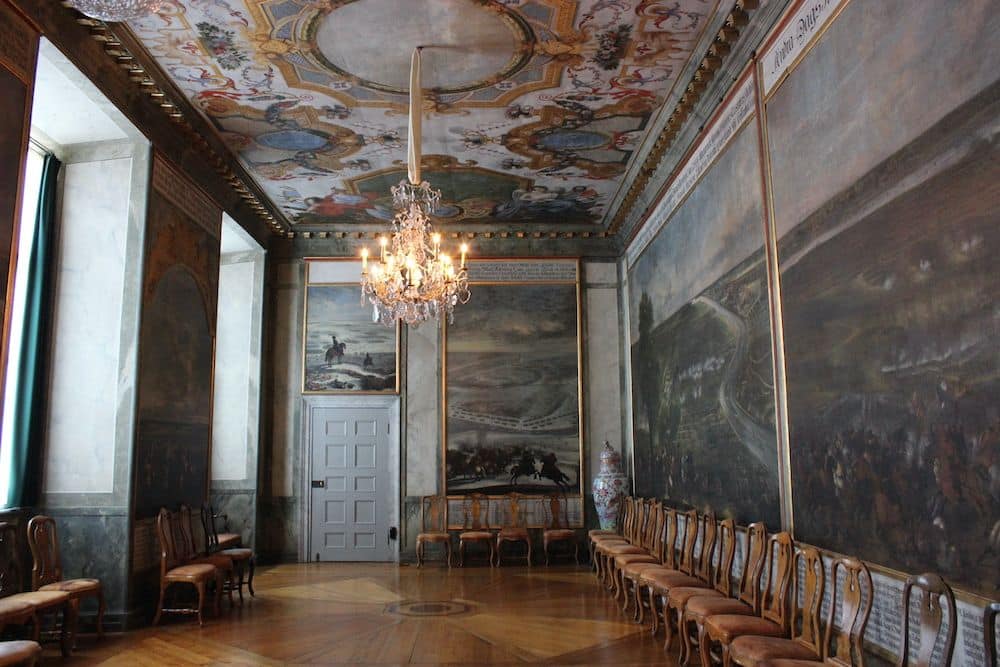 A room in Drottningholm palace with painted ceiling and walls.