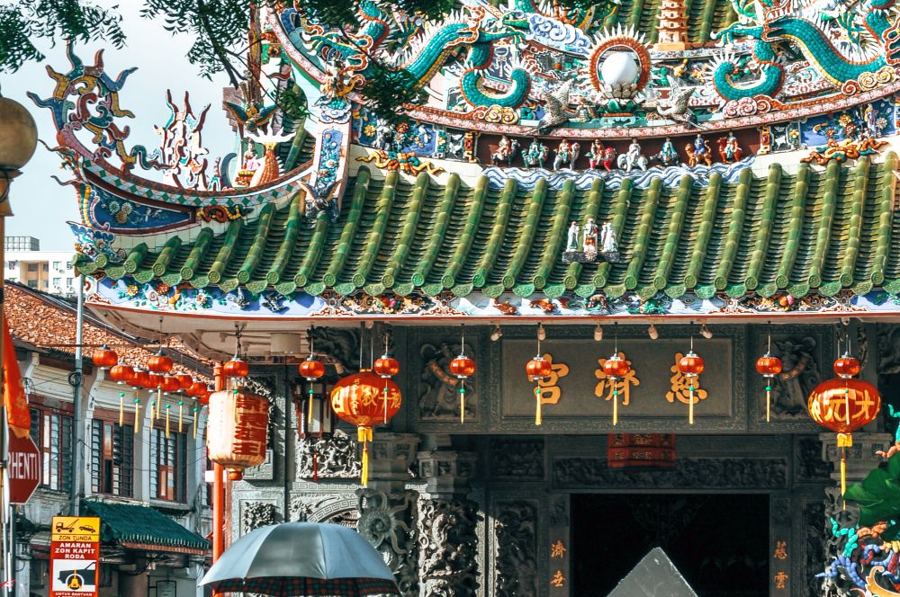 Very ornate Chinese-style roof detail with red lanterns hanging from the eaves.