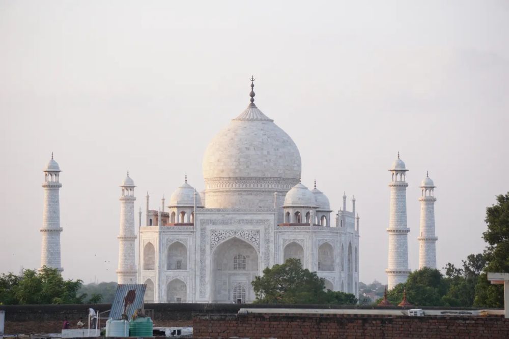 A view of the Taj Mahal seen from an angle, accentuating how white the building is.