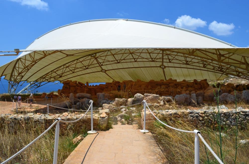 Rock structures under a large tent-like roof.