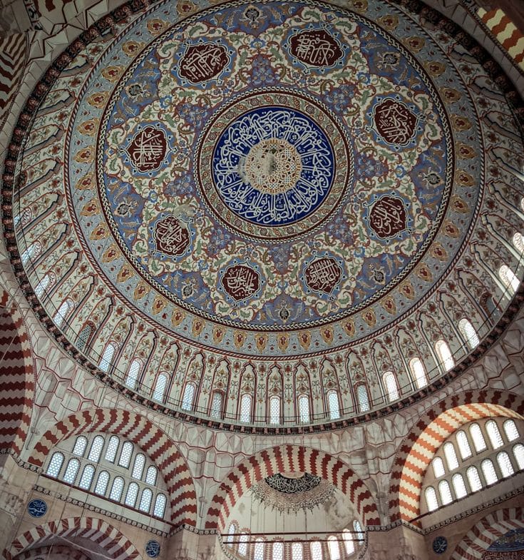 Looking up at the inside of the mosque's dome: very ornately decorated.