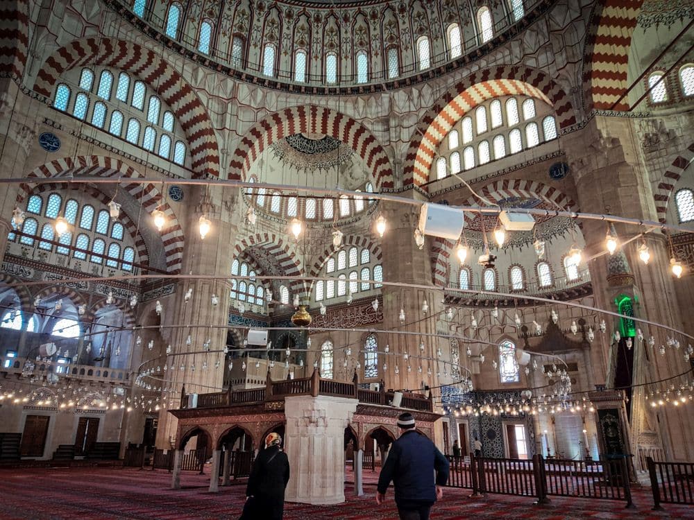 Interior view of the mosque with many windows and arches.
