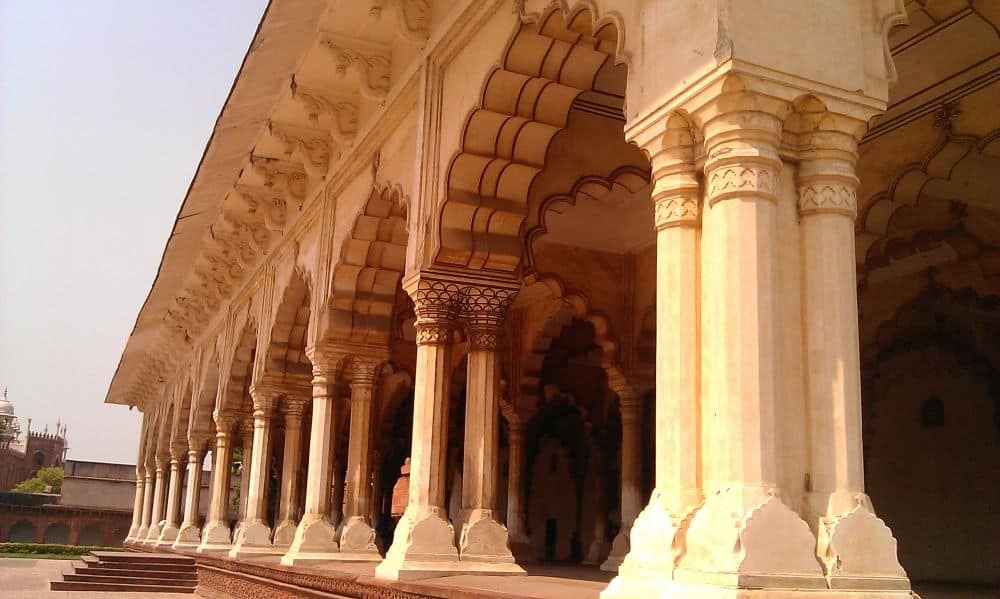 A row of ornate pillars and arches between them forming a portico along the front of a building