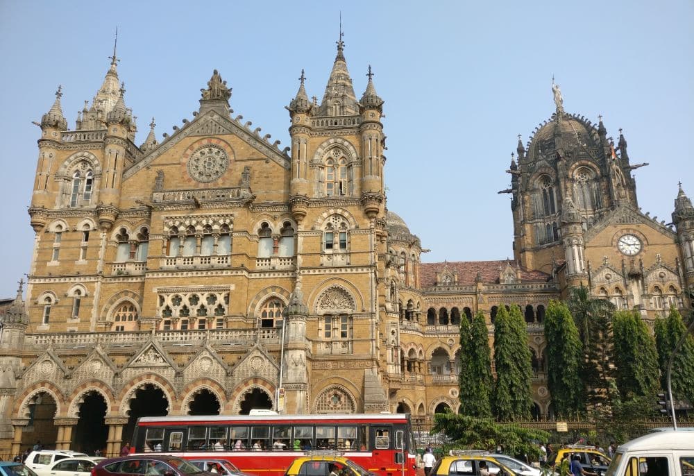 The main entrance facade of CST with arched entrances and towers framing the entrance.