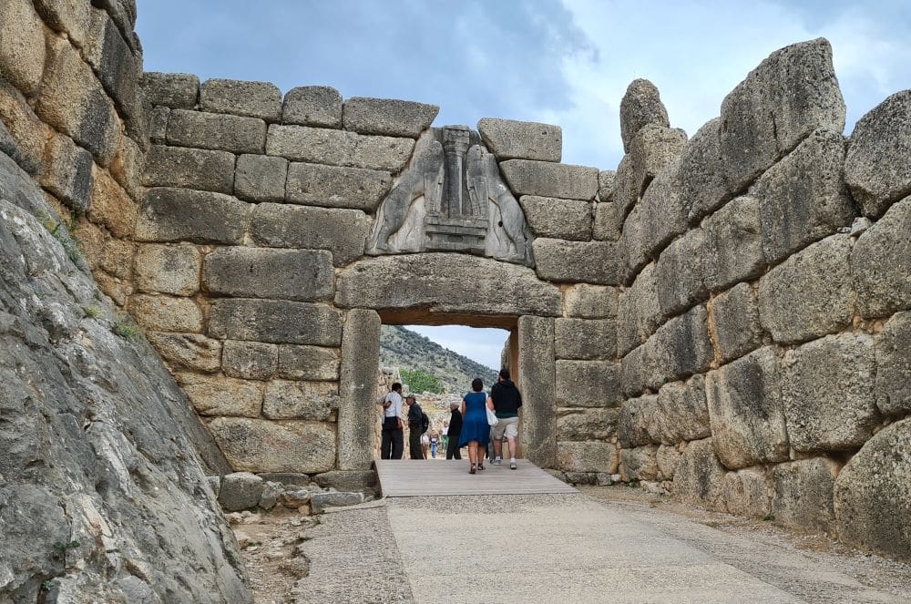 A large square entranceway of very large rough stones, with a carving above it.