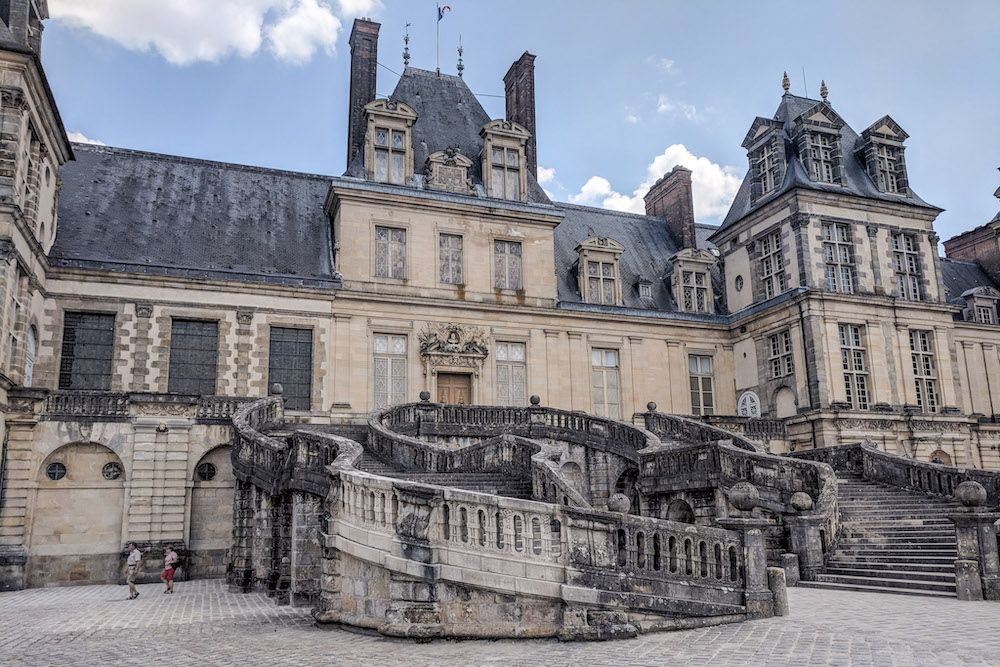 The central entrance to Fontainebleau Palace with its curving double staircase.