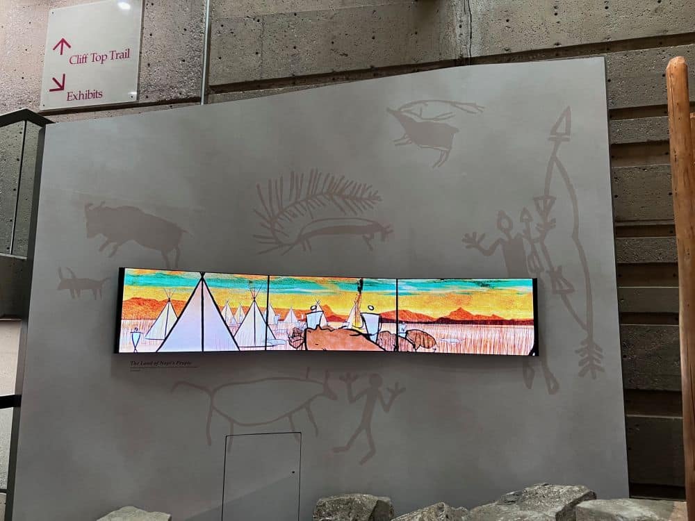 An illustration on a wall shows tepees in a cluster.