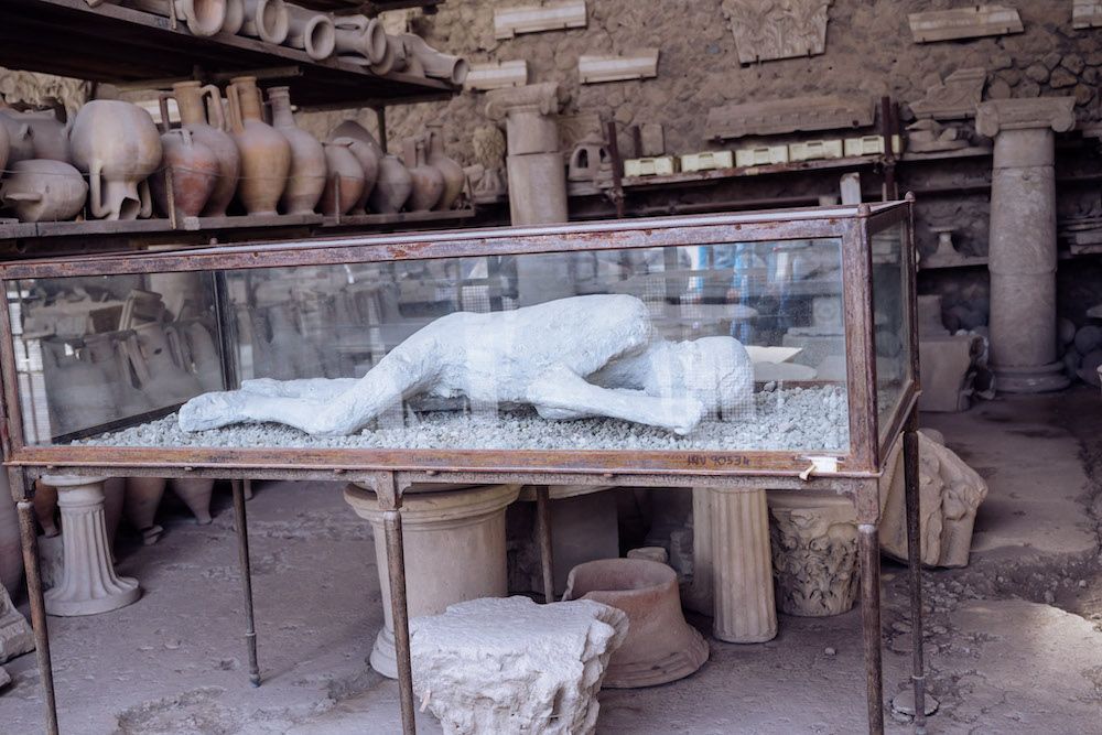 In a glass case, the plaster cast of a person killed in the eruption.