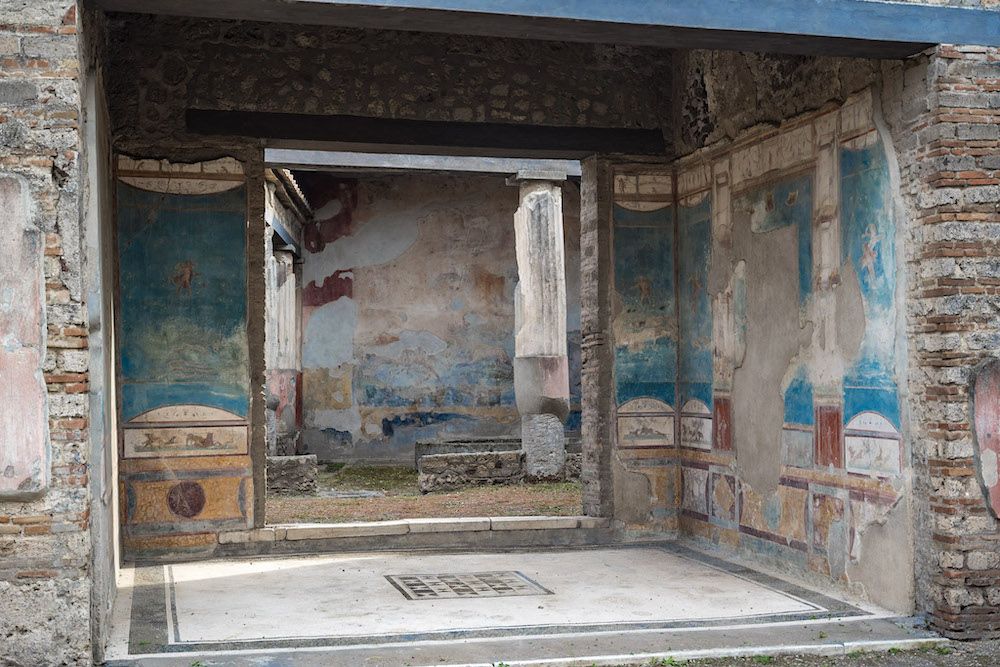 A room with some wall paintings still visible.