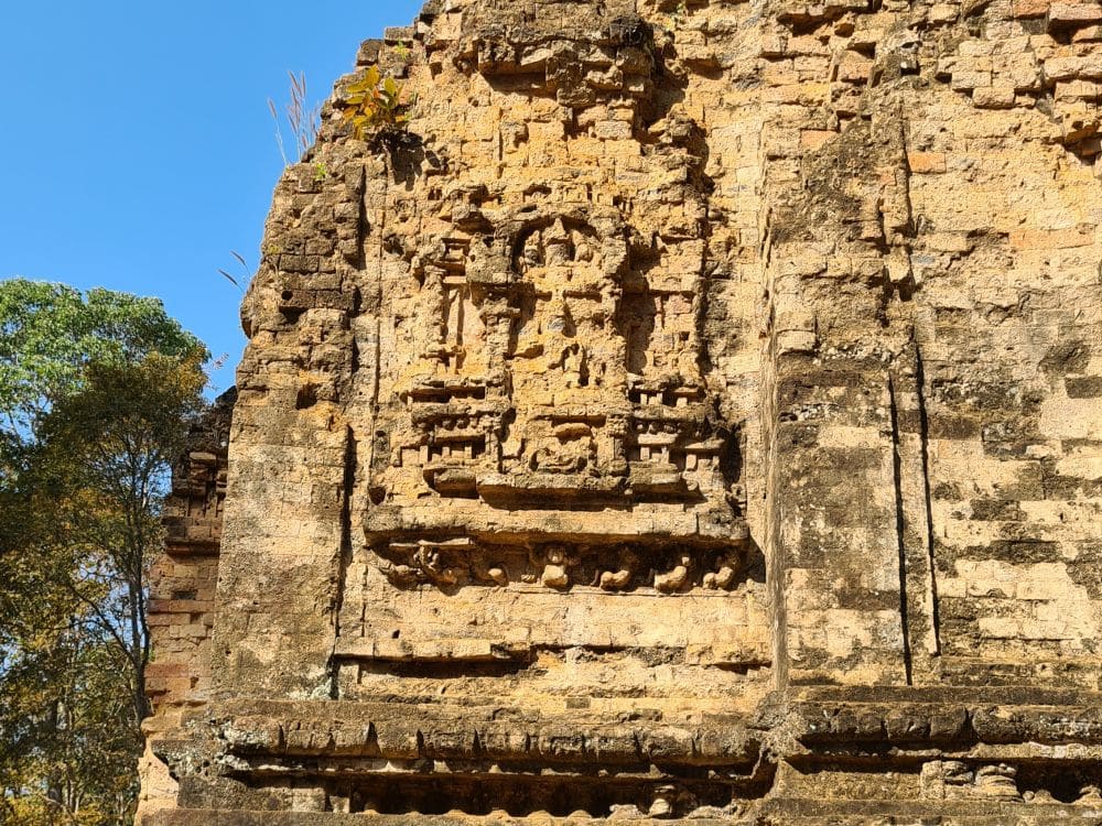 A rather eroded image on the side of a temple: rectangular, with various god figures.