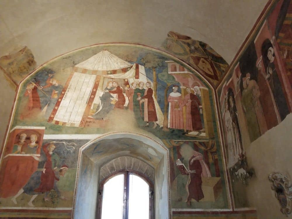 Almost intact and still bright frescoes showing people in medieval dress.