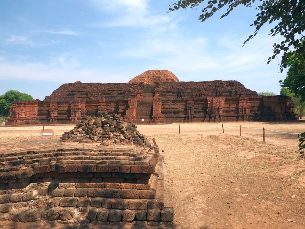 A large pyramid, but flat on the top, made of dark red stone in two steps.