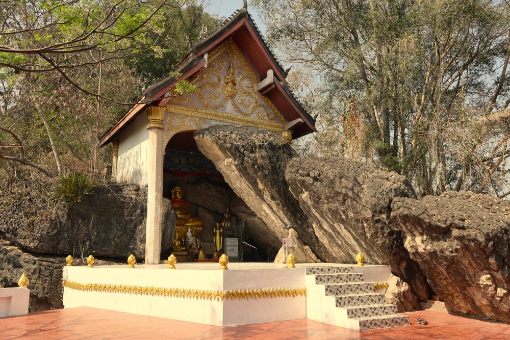 A temple whose right side is carved out from a wall of rock.