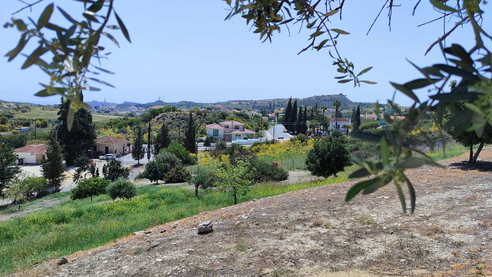 View down a hill toward a small village from Choirokoitia.