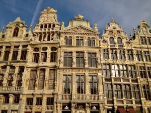 A row of buildings decorated with gold leaf and with ornate gables.