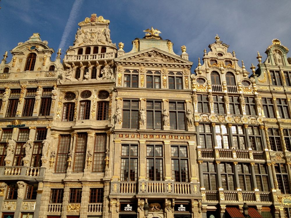 A row of buildings decorated with gold leaf and with ornate gables.