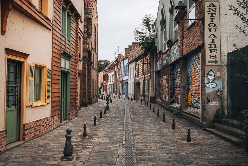 A narrow city street lined with small buildings.