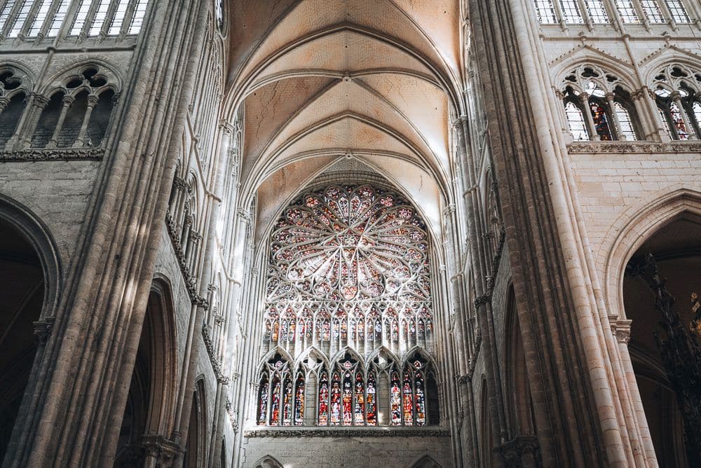 High arched ceiling and ornate rose window.