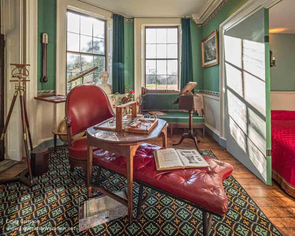 A lounge chair in a small room has table top over it with a contraption on it of some sort.