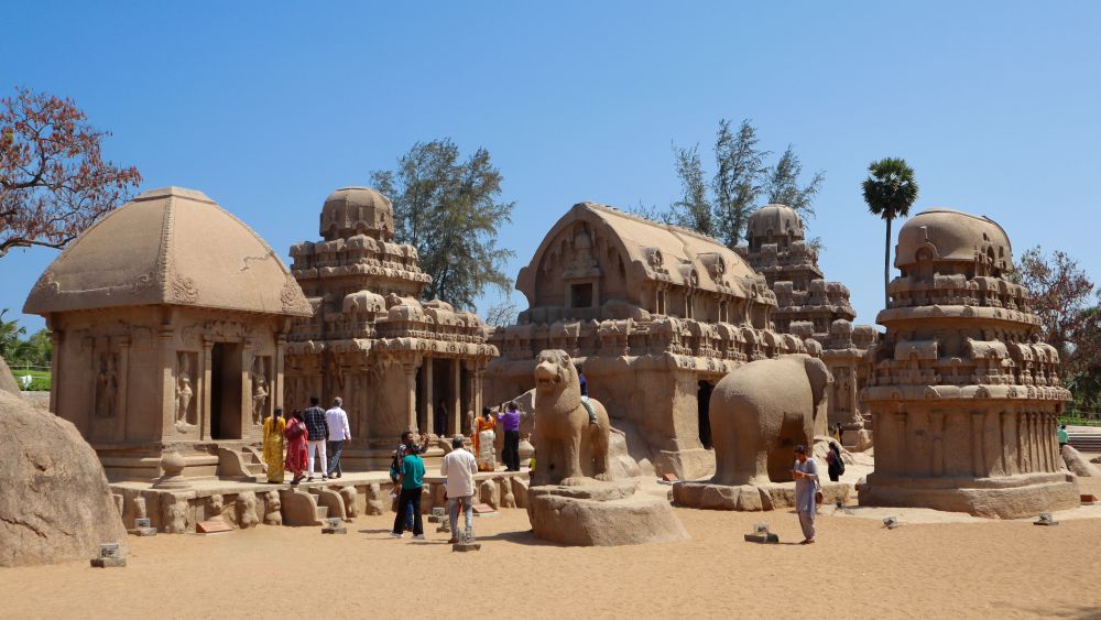 Four small temples and life-sized carvings of an elephant and another animal, possibly a lion.