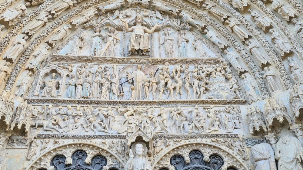 bas-relief of the Last Judgement with a semi-circular arch of carvings around it.