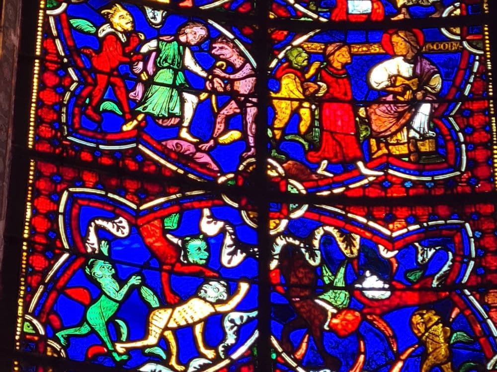 Stained-glass detail that portrays some odd creatures. Devils?