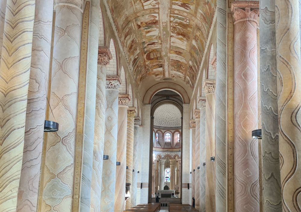 View down the nave of the church, with the ceiling painted in rectangular panels.