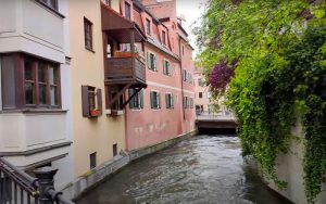 A row of pastel buildings along a canal.