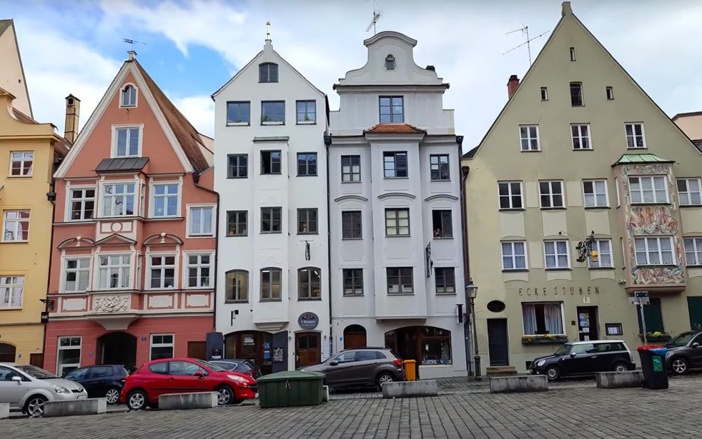 A row of tall, narrow, pastel-colored buildings.