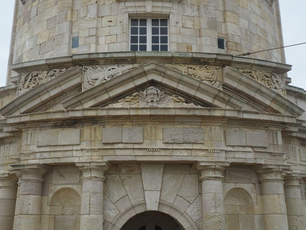 Carved ionic columns, a face in the pediment above the doorway, etc.