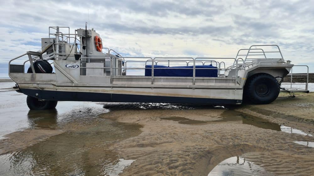 A boat of sorts, but with a very large tire in the front and two somewhat smaller at the back.