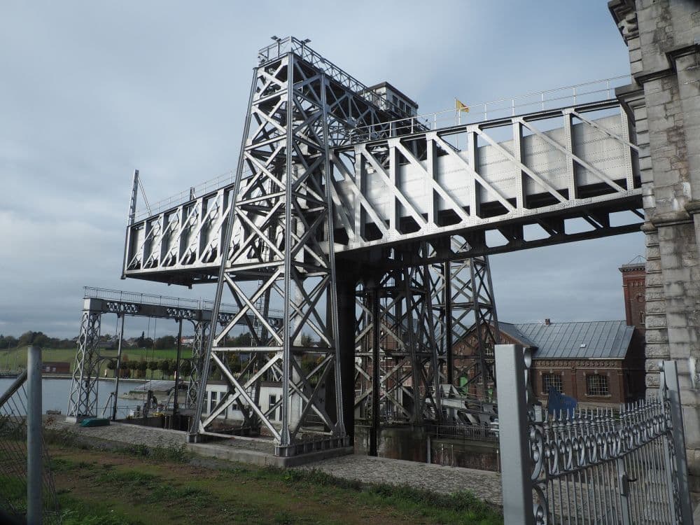 A large metal structure jutting horizontally, supported by a structure of steel beams.