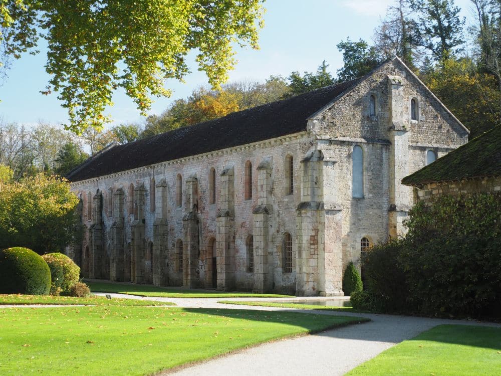 A rectangular building, 2 large stories, of white stone.