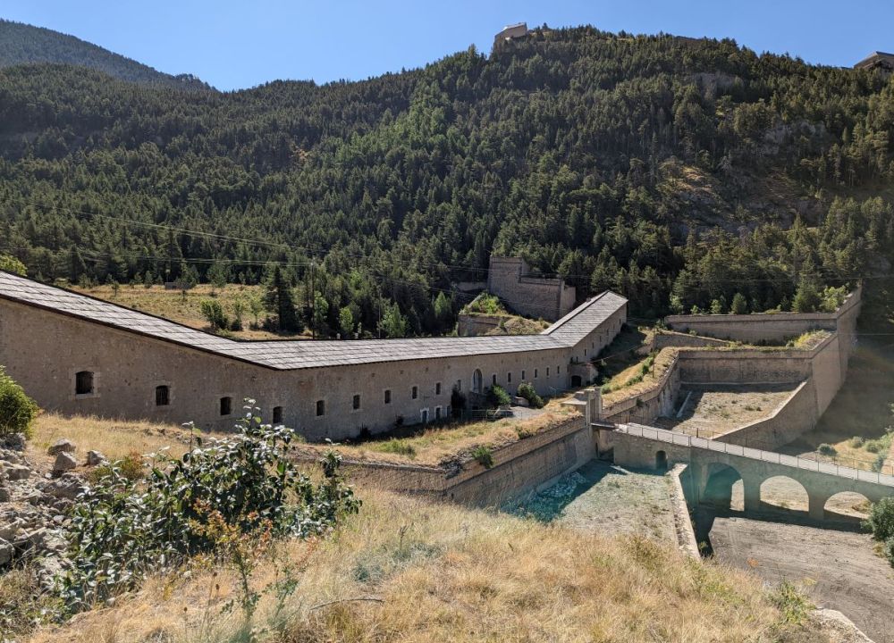 A long low stone building crossing a valley.