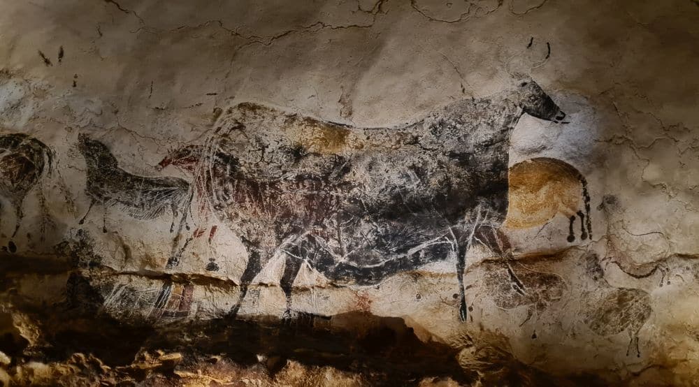 A black bull painted onto a rock surface.