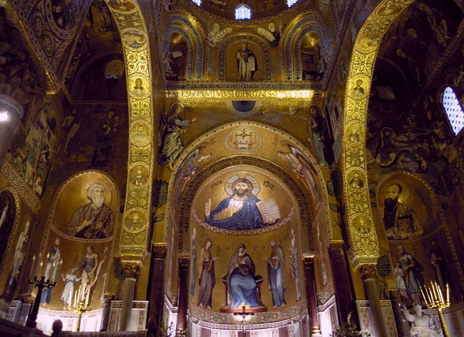 An ornate interior where the walls are covered with mosaic images and lots of gold.