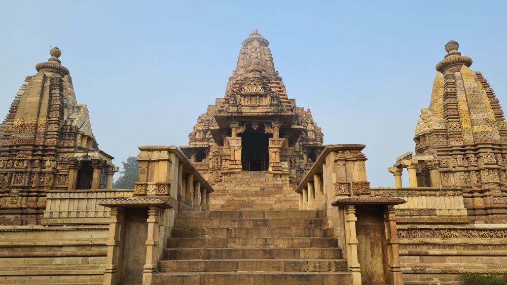 A temple as seen from the front, looking up the stairs. Temple in the center, a smaller shrine on either side.