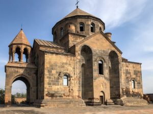 A small church with a cylindrical dome in the center.