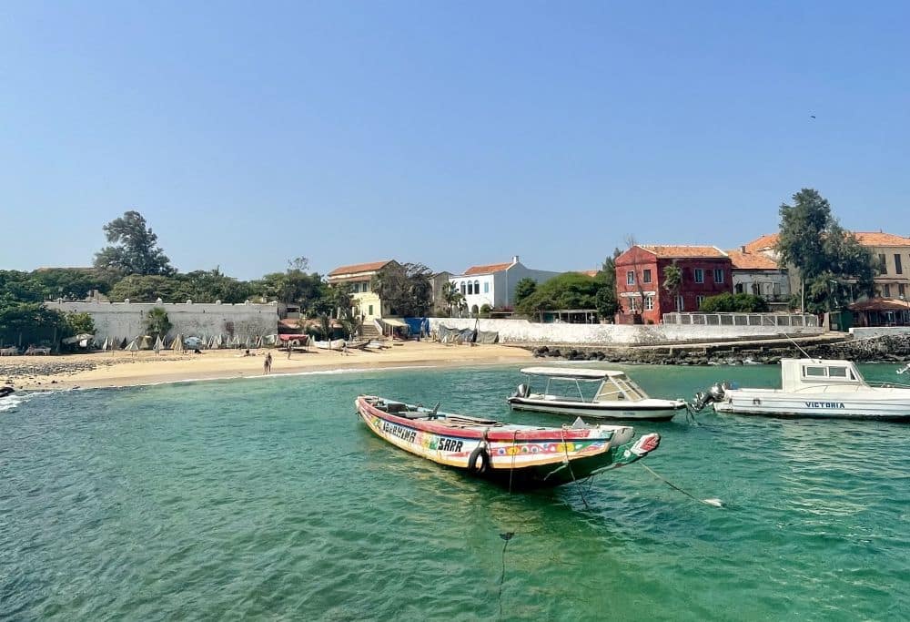 A calm harbor with some small fishing boats at anchor.