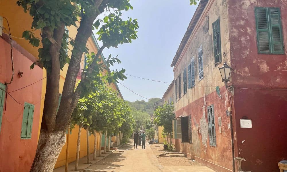 A street lined by colonial-era two-story houses.