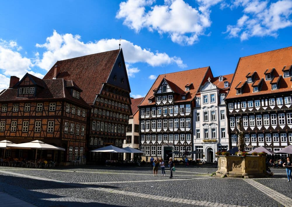 Large half-timbered buildings around a square.