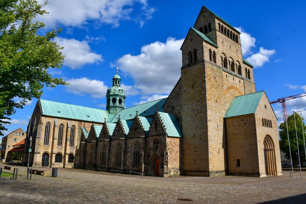 A brick church with a block-like tower at its front.