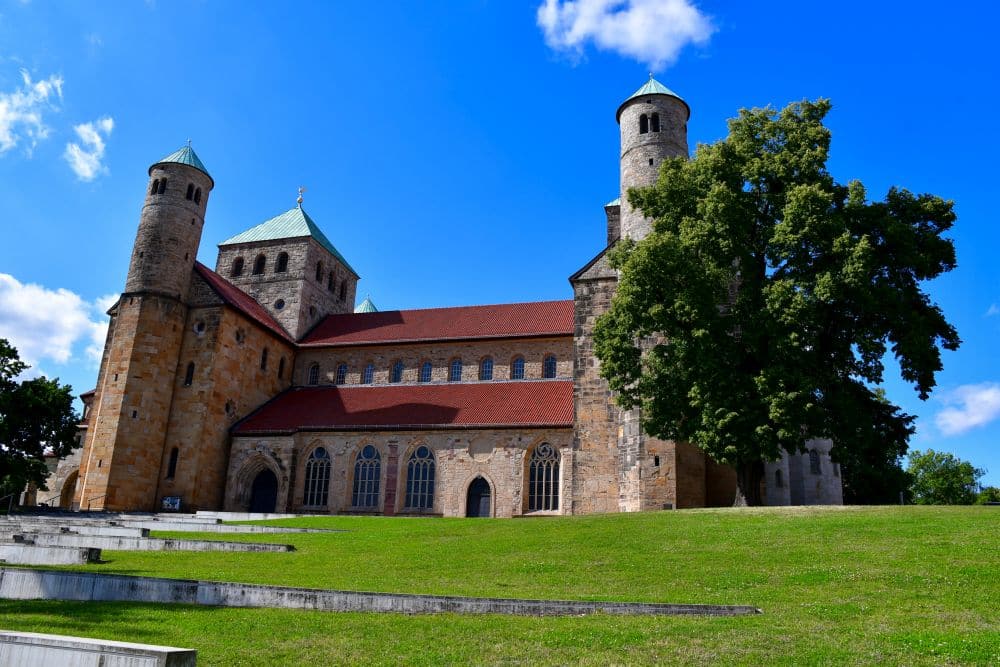 A church with red roof and short towers at either end.