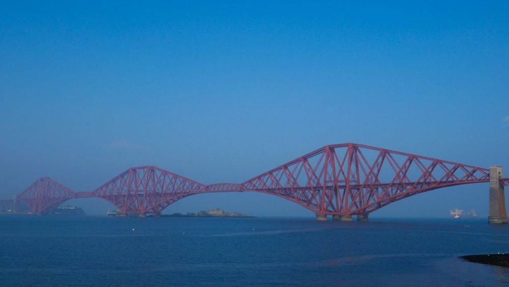 A view of three of the Forth Bridge spans from a distance.