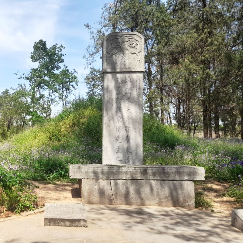 A tall stone-carved tombstone.