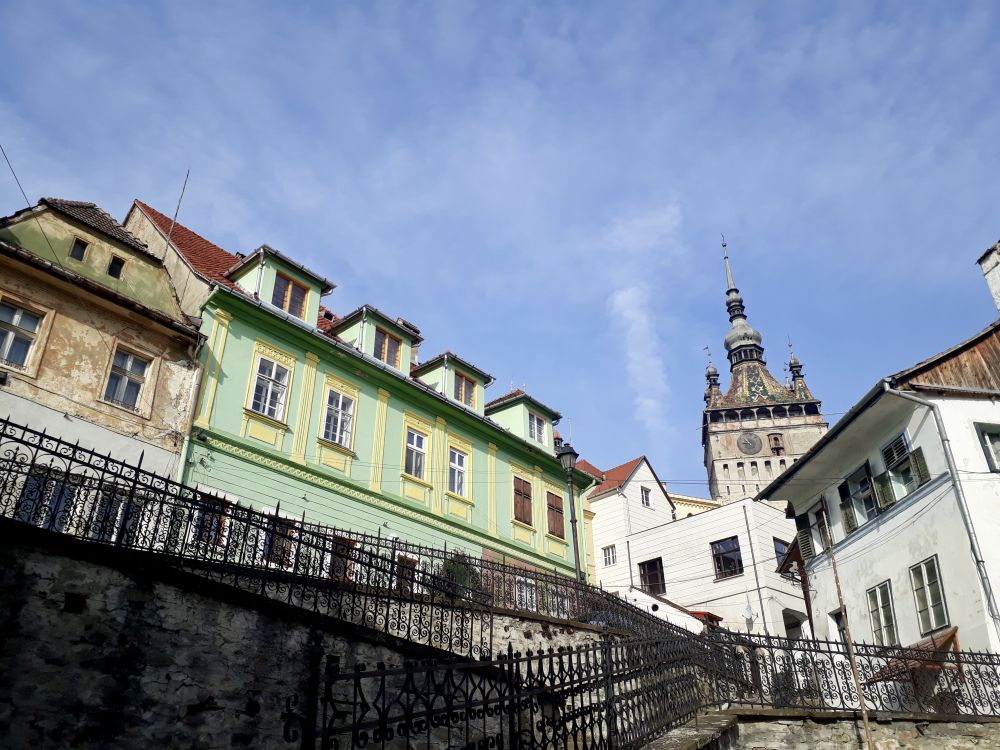 clustered white and pastel buildings, with the clock tower visible behind.
