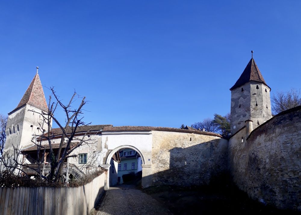 An arched gateway, fortified on each side by towers.