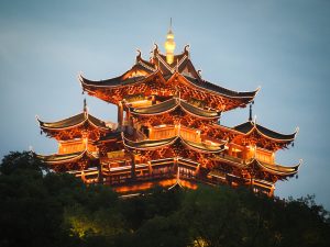 A large pavilion - more like a castle - at West Lake - lit up with lights along all of the curved roofs.